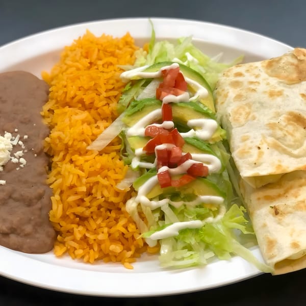 Nacho's Taqueria Grill's quesadilla plate with rice, beans, lettuce, avocado, tomatoes, and sour cream.